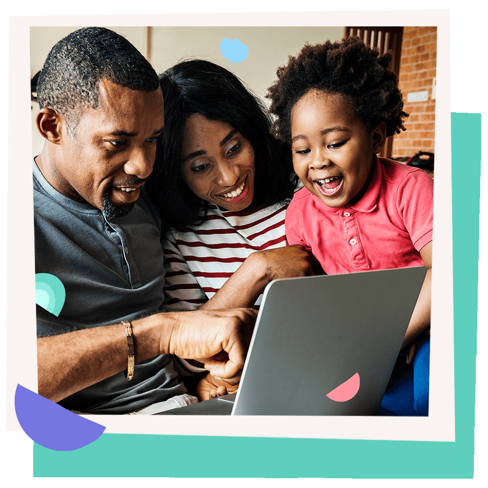 A joyful family of three looking at a laptop together.